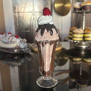 Faux chocolate sundae with fudge chocolate syrup whip and a raspberry topper